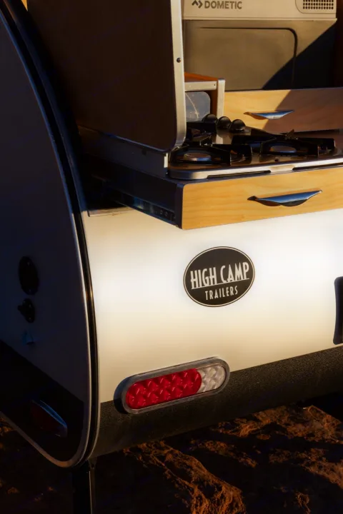 Explore with an **rv rental**! This High Camp teardrop trailer reveals its Dometic outdoor kitchen, ready for your next adventure.. Tear Drop Tear Drop 2019