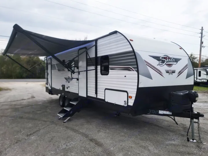 White Shasta travel trailer with an extended awning, ready for your RV rental adventure.. Forest River Shasta 2022