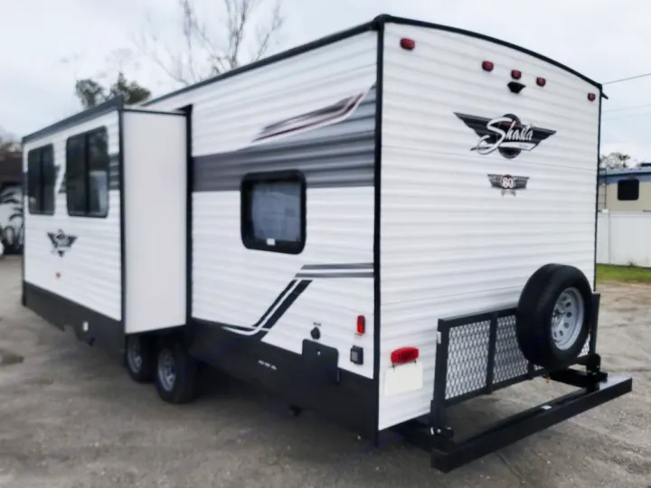 White Shasta travel trailer RV rental with slide-out extended and rear cargo rack/spare tire.. Forest River Shasta 2022