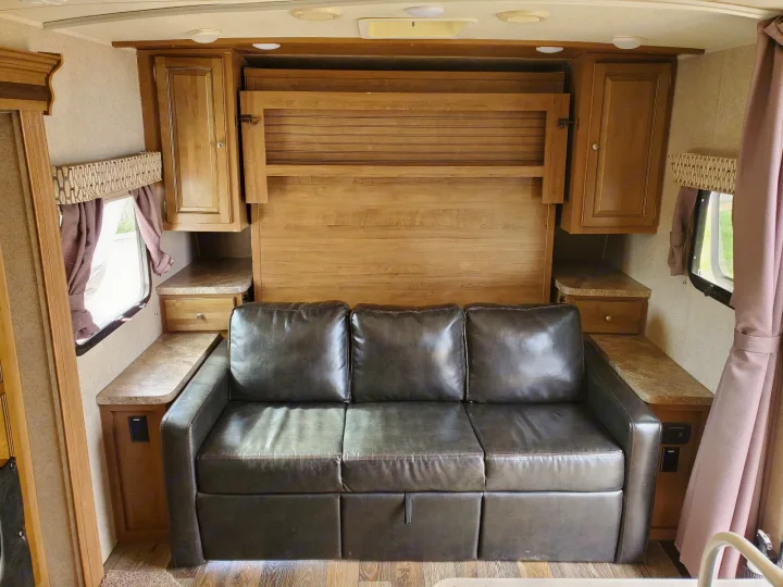 RV rental: Relaxing interior with a dark sofa sleeper, fold-down bed, and ample storage.. Forest River Rockwood Mini Lite 2017