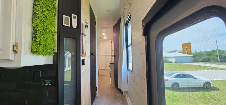 Step inside this cozy RV rental: modern decor, kitchen area, and a window view of the outdoors.. Heartland Edge 2016