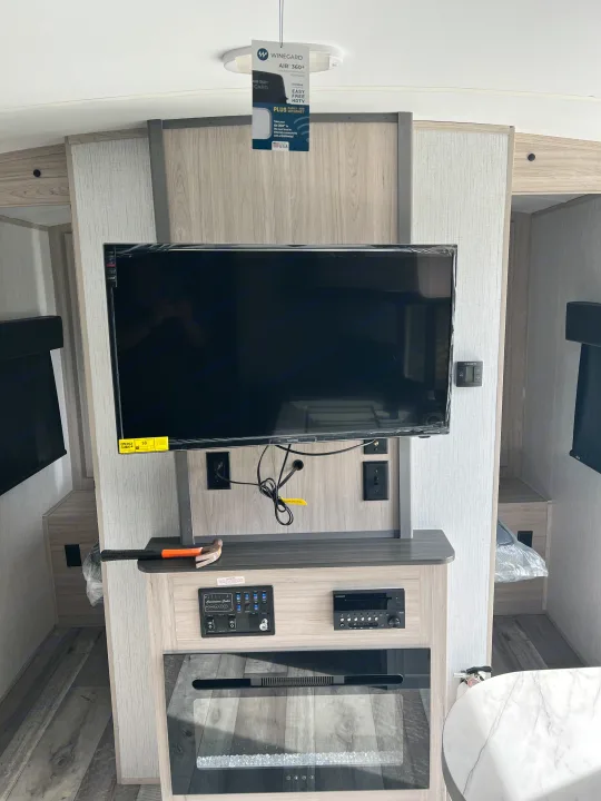 RV rental interior: Entertainment center with a new TV, electric fireplace, and user control panels for comfort.. Heartland RVs Sundance Ultra Lite 2022