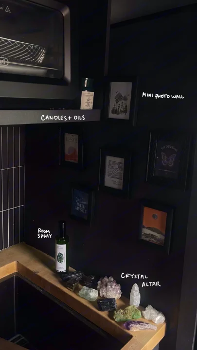 Cozy dark interior of an RV rental: microwave, mini photo wall, and crystal altar on a wooden counter. Personalized compact space.. Dodge Ram Promaster 2500 2021