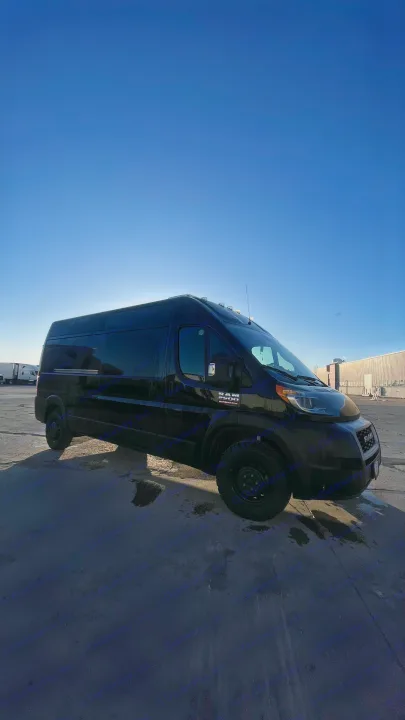 A sleek black Ram ProMaster van, perfect for rv rental, parked outdoors under a bright blue sky.. Dodge Ram Promaster 2500 2021