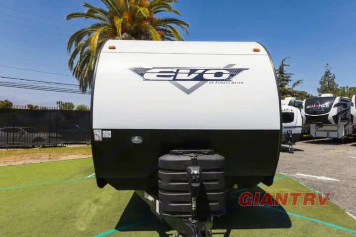 White Forest River Evo travel trailer shown head-on. Ideal for your next RV rental adventure. Other RVs visible.. Forest River Evo CSJT2650G 2023
