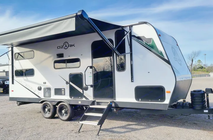 This white Ozark Ascent travel trailer, ideal for an RV rental, is ready for adventure with its extended awning and steps.. Forest River ozark 2440bhkx 2024