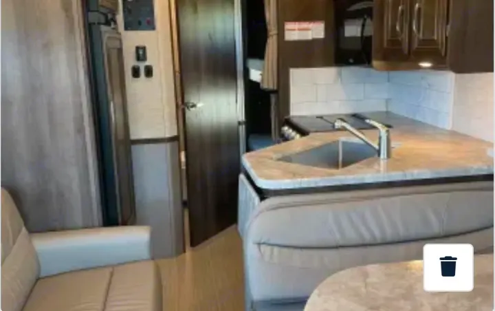 Inside this cozy RV rental: a well-equipped kitchen, comfortable seating area, and sleeping berths for your next adventure.. Entegra Coach Vision 2021