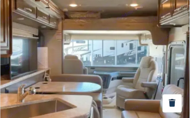 Explore this RV rental's spacious motorhome interior, featuring a kitchen, dining area, and front cab bunk.. Entegra Coach Vision 2021