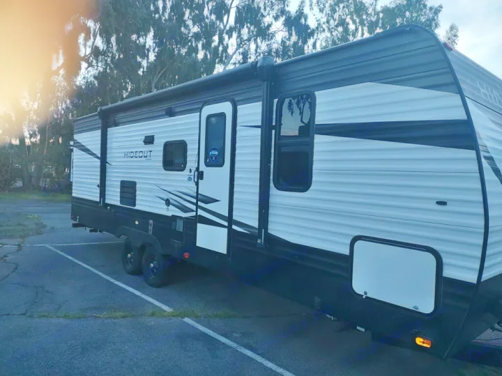 Modern Hideout RV rental, a black and white travel trailer, parked on a lot, signaling a new adventure ahead.. Keystone Hideout 2020