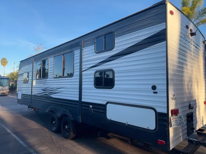 Keystone Hideout RV rental: A sleek grey and black travel trailer parked outdoors, awaiting its next journey.. Keystone Hideout 2020