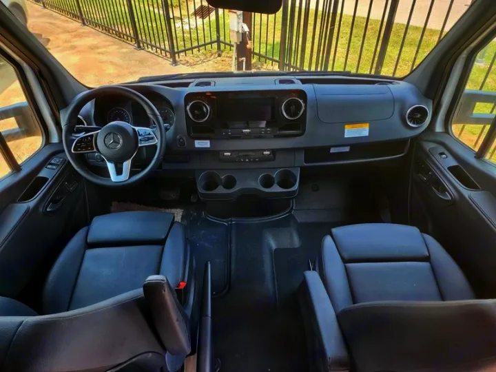 Inside a spacious Mercedes-Benz Sprinter van, ideal for RV rental adventures. View of dashboard & front seats.. Entegra Coach Qwest 24L 2024