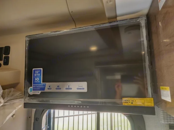 New Connex 32-inch HD TV with built-in soundbar for RV rental entertainment, still in protective wrap.. Entegra Coach Qwest 24L 2024