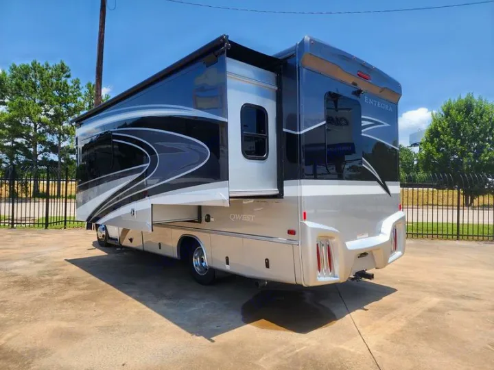 Sleek black & silver Entegra Qwest RV rental. This modern motorhome showcases its extended slide-out.. Entegra Coach Qwest 24L 2024