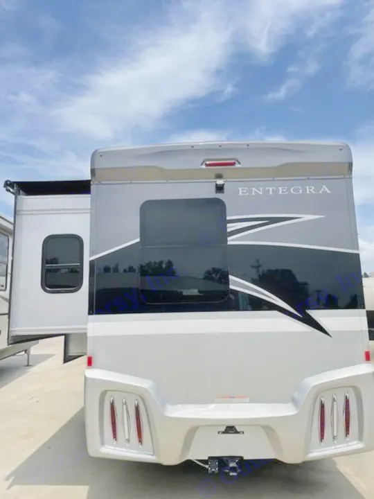 Rear view of a silver Entegra RV motorhome, ideal for rv rental adventures. Features an extended slide-out.. Entegra Coach Qwest 24L 2024