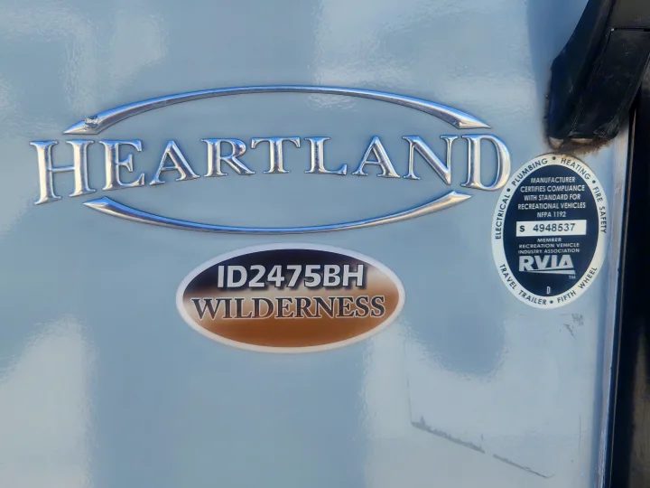 Close-up of a Heartland Wilderness travel trailer (ID2475BH) showing RVIA certification. Available for RV rental.. Heartland Wilderness 2019