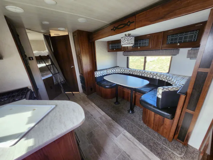 Spacious RV rental interior with kitchen, dinette, and bunk beds, perfect for travel.. Heartland Wilderness 2019