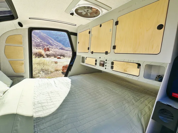 Cozy Escapod rv rental camper interior featuring a comfortable bed, built-in storage, and panoramic desert views.. Escapod Escapod Trailer 2023