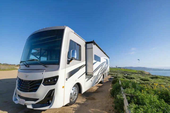 Discover the beauty of a coastal getaway with this spacious RV rental, parked amidst green hills overlooking the ocean.. Fleetwood Fortis 2020