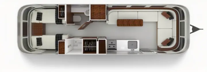 An overhead floor plan of an rv rental interior, showing twin beds, a bathroom, kitchen, and a large U-shaped dining/lounge area.. Airstream Globetrotter 2020