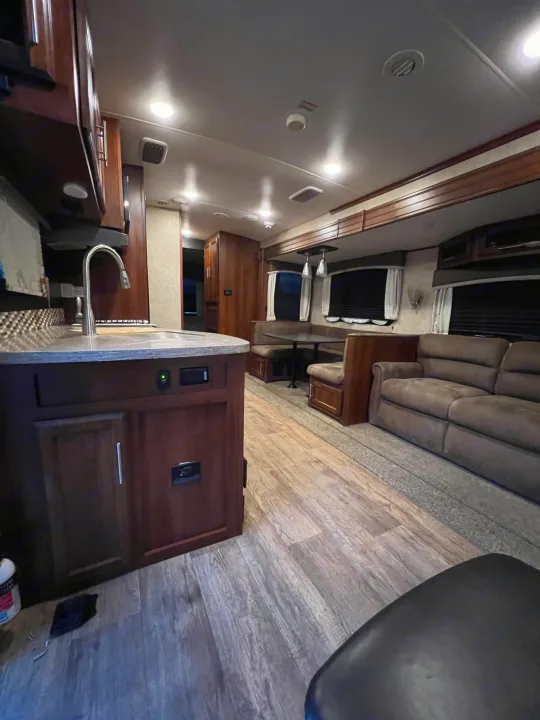 Spacious and modern RV rental interior featuring a full kitchen, comfortable dinette, and cozy living area. Perfect for travel.. Jayco Eagle HT 2018