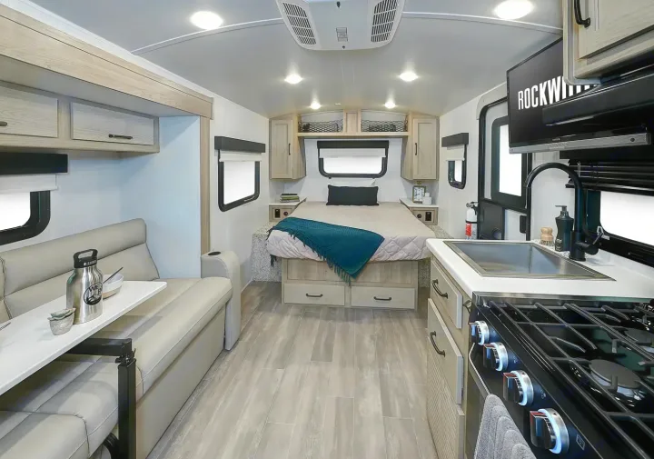 Spacious RV rental interior with a full kitchen, comfortable dinette, and bedroom area, perfect for travel.. Forest River Rockwood Geo Pro 2024