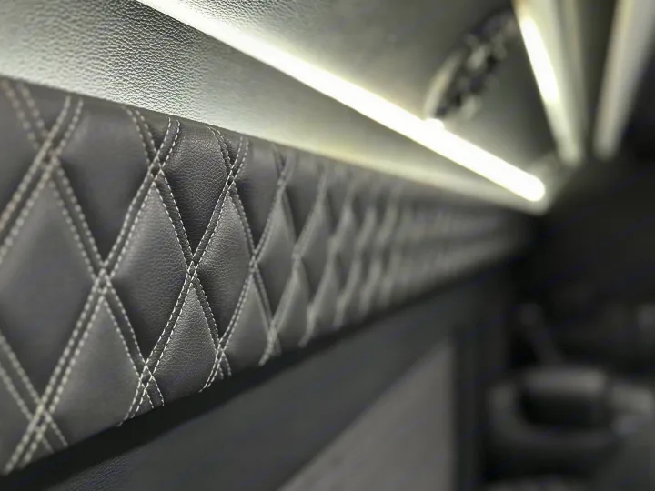 Inside your RV rental: plush, diamond-stitched walls and bright LED lighting for premium travel comfort.. Mercedes Benz Sprinter 3500XD 2024