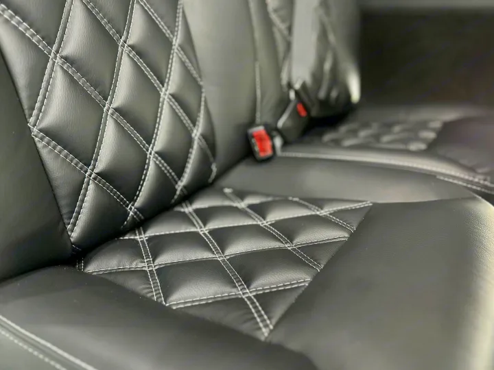 Explore in comfort! Our RV rental features plush black diamond-stitched seats with white quilting. Ready for adventure.. Mercedes Benz Sprinter 3500XD 2024