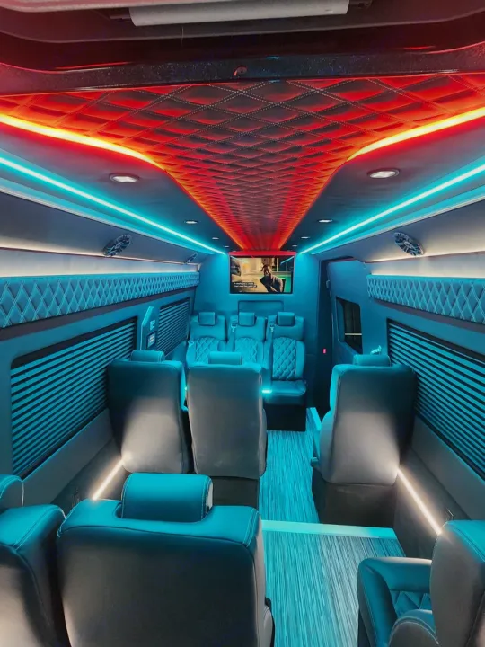 Indulge in an RV rental with this luxury custom van interior. Enjoy vibrant lighting, plush seats, & screen.. Mercedes Benz Sprinter 3500XD 2024