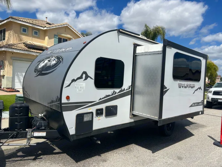 Light gray Wolf Pup travel trailer parked, ideal for your next RV rental and outdoor adventure.. Forest River Cherokee Wolf Pup Black Label 2022