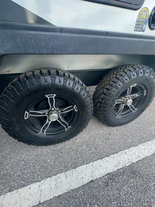 Two sturdy Goodyear Wrangler off-road tires with black rims are seen on an RV rental.. Minnie Micro Minnie 2024