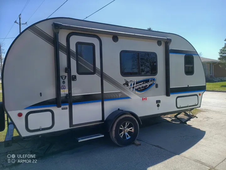 A grey and white Hummingbird by Jayco travel trailer, ready for your next RV rental adventure.. Jayco Hummingbird 2018