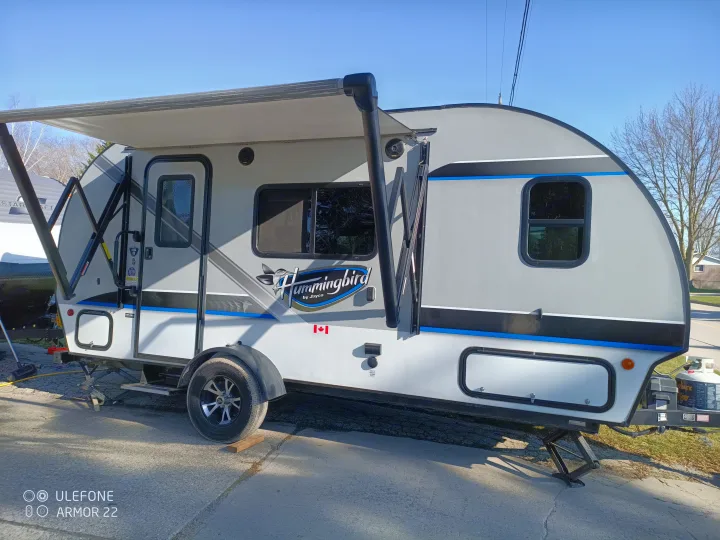 Explore the outdoors! This Jayco Hummingbird travel trailer, with its awning extended, is perfect for an rv rental getaway.. Jayco Hummingbird 2018