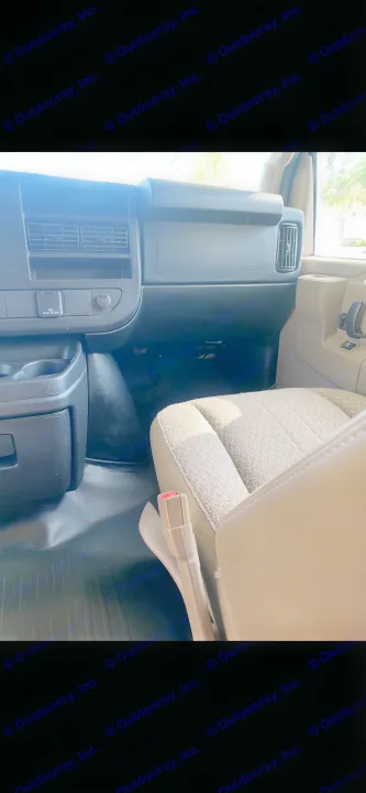 Inside an RV rental: passenger front cabin with dashboard power outlets, durable floor, and fabric seat.. Thor Four Winds 2018