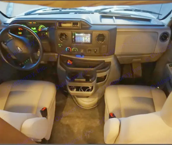 Interior view of an RV rental, featuring the Ford dashboard, steering wheel, and front bucket seats.. Adventurer Adventurer Motorhome 2019
