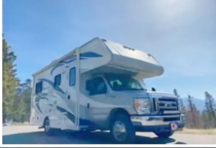 Explore nature with this spacious RV rental, a modern motorhome parked under a clear sky for your next road trip adventure.. Adventurer Adventurer Motorhome 2019