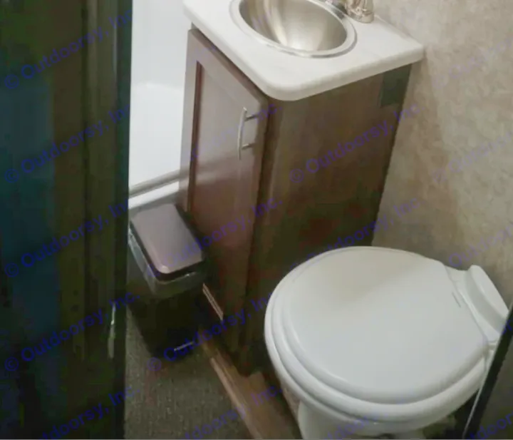 This RV rental bathroom features a compact toilet, sink vanity, and shower, showcasing a functional space.. Adventurer Adventurer Motorhome 2019
