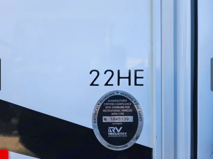 RV rental motorhome: Side view showing model "22HE" and an RV Industry Association compliance sticker for safety.. Thor Freedom Elite 2022