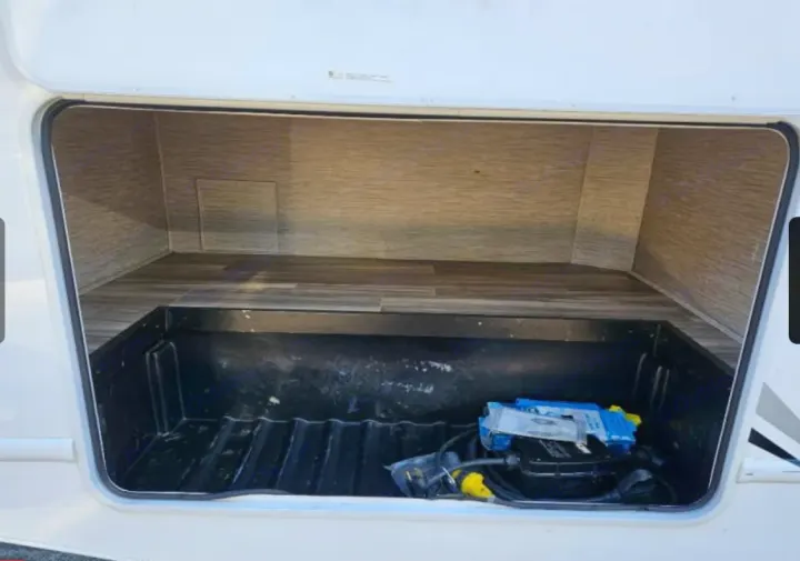 RV rental storage bay showing interior shelf, lower bin with electrical hookups. Ideal for gear.. Thor Freedom Elite 2022