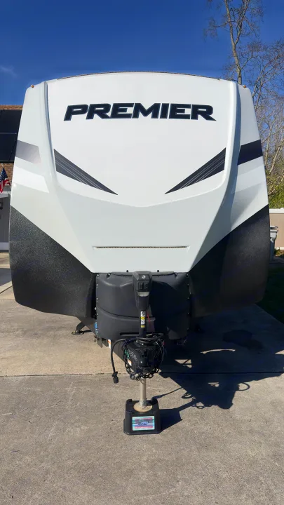 Front view of a white Premier RV with hitch, parked on concrete. Ideal for your next rv rental adventure.. Keystone RV Bullet Premier Ultra Lite 2022