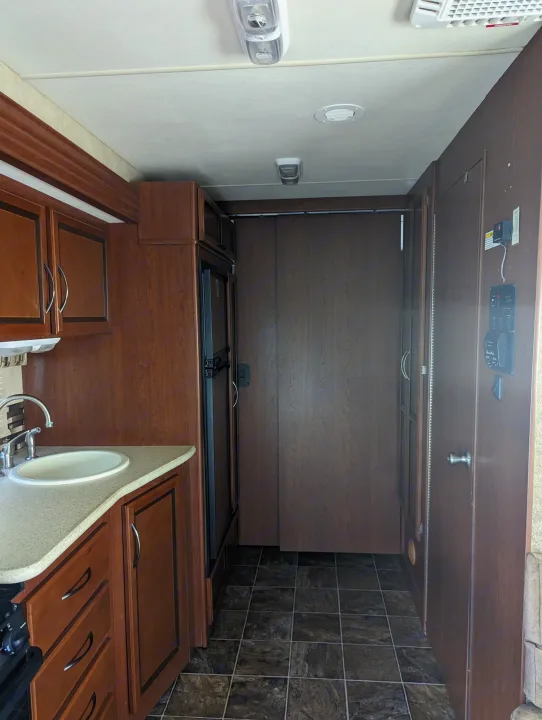 RV rental: Interior view of kitchen & hall. Features wood cabinets, sink, fridge, and tiled flooring.. Thor Other 2014