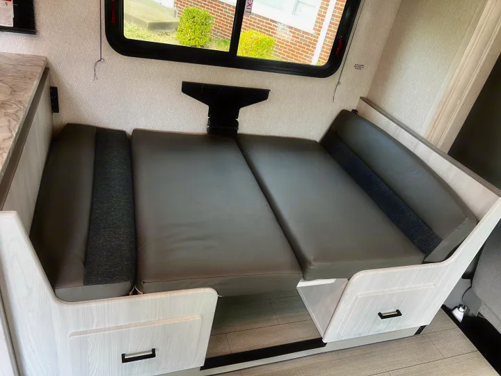 RV rental: Dinette area configured as a comfortable bed with gray cushions, ready for rest.. 1FDXE4FN9RDD14726 3100FB 2023