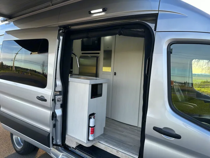 Explore comfort in this modern rv rental camper van interior, featuring a compact kitchen & ample storage.. Pleasure-Way Pleasure-Way Class B 2024