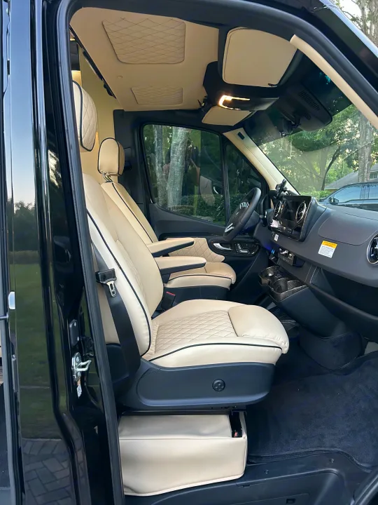 RV rental's luxurious cream leather interior, showcasing diamond-stitched seats and custom roof panels.. Mercedes-Benz Sprinter 2024