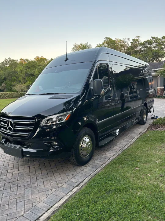 Sleek black Mercedes Sprinter van for RV rental, parked on a paver driveway. Ready for luxury travel & adventure.. Mercedes-Benz Sprinter 2024