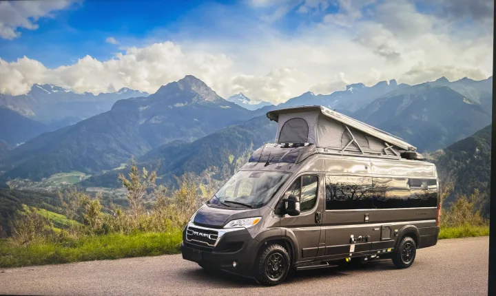 Pop-top camper van rv rental on a mountain road. Explore scenic landscapes & outdoor adventures.. Thor Sequence 2024