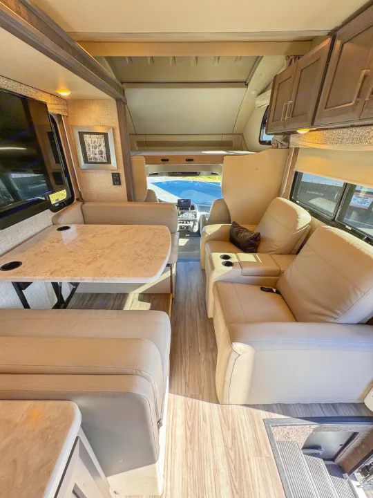 Step inside this modern RV rental! Features a comfy dining booth, recliners, and bright living space.. Thor Motor Coach Pasadena  Super-C 2023