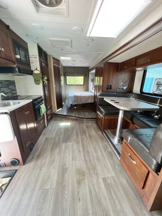Step inside this modern rv rental, featuring a full kitchen, comfortable dining booth, and cozy bedroom. Ideal for road trips.. Forester GTS 2018