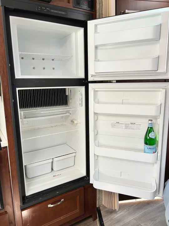 This clean RV refrigerator and freezer with mostly empty shelves and a S.Pellegrino bottle is perfect for your rv rental.. Forester GTS 2018