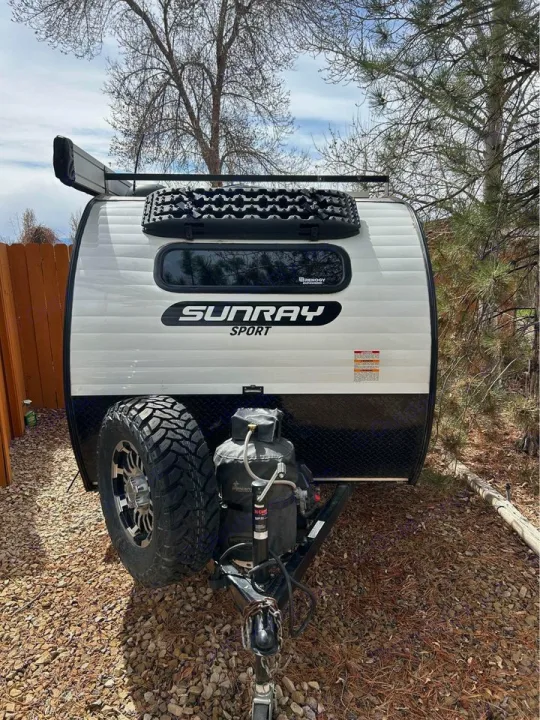 Sunray Sport RV rental: compact travel trailer with recovery tracks, spare tire, and propane tanks.. Sunset Park RV SunRay 2020