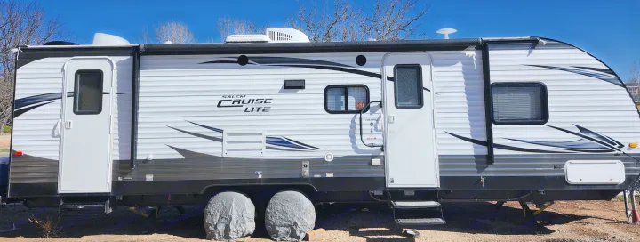 This white Salem Cruise Lite travel trailer is ready for your next rv rental adventure, parked under a clear blue sky.. Forest River Salem Cruise Lite 2017